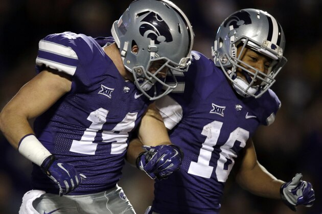 Kansas State wide receiver Curry Sexton (14) celebrates his touchdown with wide receiver Tyler Lockett (16) during the second half of an NCAA college football game in Manhattan, Kan., Saturday, Nov. 29, 2014. Kansas State won 51-13. (AP Photo/Orlin Wagner)
