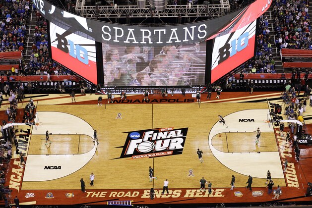 Fans watch Michigan State players during a practice session for the NCAA Final Four tournament college basketball semifinal game Friday, April 3, 2015, in Indianapolis. Michigan State plays Duke on Saturday. (AP Photo/David J. Phillip)