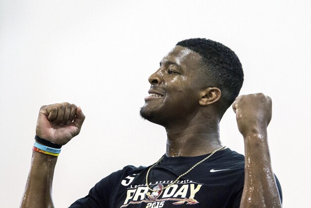 Jameis Winston pumps his fists after a pass competition during Florida State football pro day in Tallahassee, Fla., Tuesday, March 31, 2015.  (AP Photo/Mark Wallheiser)