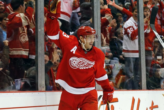 Detroit Red Wings center Pavel Datsyuk (13) celebrates scoring a goal against the Philadelphia Flyers in the second period of an NHL hockey game in Detroit Wednesday, Nov. 26, 2014. (AP Photo/Paul Sancya)