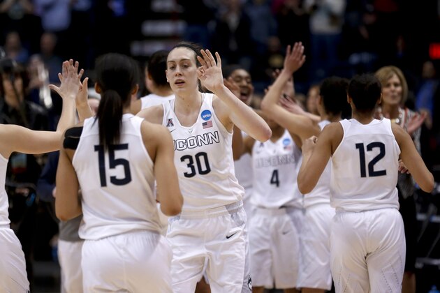 Connecticut's Breanna Stewart (30) and teammates celebrate their 91-70 win over Dayton during a regional final game in the NCAA women's college basketball tournament Monday, March 30, 2015, in Albany, N.Y. (AP Photo/Mike Groll)