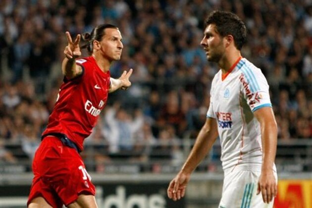Paris Saint Germain's Swedish forward Zlatan Ibrahimovic, left,  reacts after scoring against Marseille, asMarseille's French forward Andre-Pierre Gignac looks on, during their League One soccer match, in Marseille, southern France, Sunday, Oct.7, 2012. (AP Photo/Claude Paris)