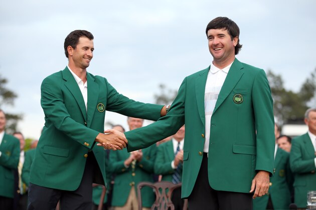 AUGUSTA, GA - APRIL 13:  Adam Scott of Australia presents Bubba Watson of the United States with the green jacket after Watson won the 2014 Masters Tournament by a three-stroke margin at Augusta National Golf Club on April 13, 2014 in Augusta, Georgia.  (Photo by Ezra Shaw/Getty Images for Golfweek)
