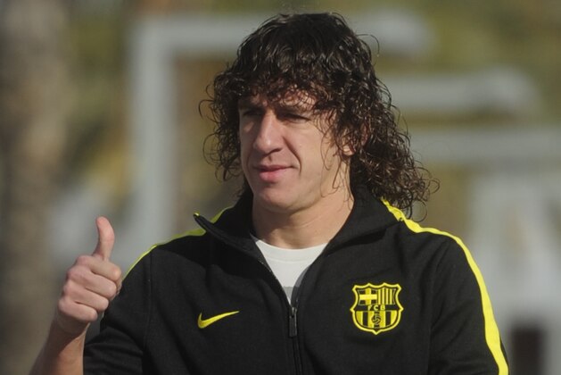 FILE  -  In this Nov. 27, 2010 file photo FC Barcelona's Carles Pujol gestures,  in San Joan Despi, near Barcelona, Spain. Puyol reluctantly quit football on Thursday, May 15, 2014,  his knees no longer able to endure the demands of the Barcelona defense after 15 years, the most successful period in the club's history. (AP Photo/Manu Fernandez, File)