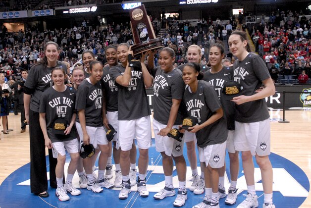 Connecticut players pose with the trophy after their 91-70 win over Dayton in a regional final game in the NCAA women's college basketball tournament Monday, March 30, 2015, in Albany, N.Y. (AP Photo/Tim Roske)