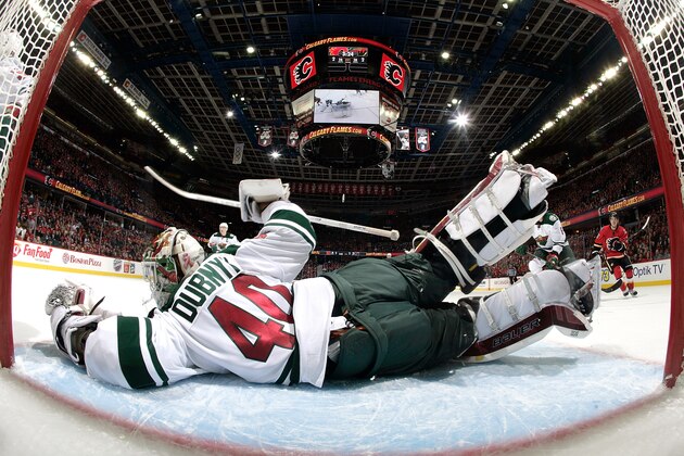 CALGARY, AB - FEBRUARY 18: Devan Dubnyk #40 of the Minnesota Wild sprawls to make a save against the Calgary Flames at Scotiabank Saddledome on February 18, 2015 in Calgary, Alberta, Canada. (Photo by Gerry Thomas/NHLI via Getty Images)