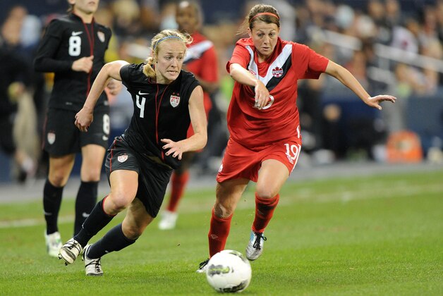 KANSAS CITY, KS - SEPTEMBER 17:  Defender Becky Sauerbrunn #4 of the United States chases down a loose ball against pressure from mid-fielder Chelsea Stewart #19 of Canada during the second half on September 17, 2011 at LiveStrong Sporting Park in Kansas City, Kansas.  The United States and Canada ended in a 1-1 tie.  (Photo by Peter Aiken/Getty Images)