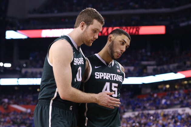 INDIANAPOLIS, IN - APRIL 04: Matt Costello #10 and Denzel Valentine #45 of the Michigan State Spartans walk off the court after being defeated by the Duke Blue Devils during the NCAA Men's Final Four Semifinal at Lucas Oil Stadium on April 4, 2015 in Indianapolis, Indiana. Duke defeated Michigan State 81-61. (Photo by Streeter Lecka/Getty Images)