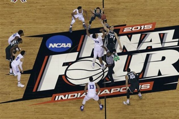 Duke's Jahlil Okafor (15) and Michigan State's Gavin Schilling (34) battle for a ball at the tip off during the first half of the NCAA Final Four tournament college basketball semifinal game Saturday, April 4, 2015, in Indianapolis. (AP Photo/David J. Phillip)