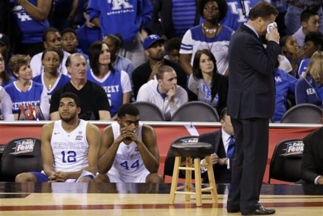 Kentucky head coach John Calipari wipes his face after the NCAA Final Four tournament college basketball semifinal game against Wisconsin Saturday, April 4, 2015, in Indianapolis. Wisconsin won 71-64.(AP Photo/Darron Cummings)