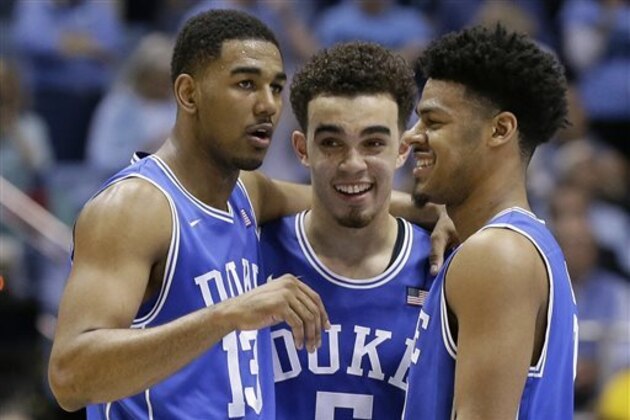 FILE - In this March 7, 2015, file photo, Duke's Matt Jones (13), Tyus Jones and Quinn Cook, right, celebrate during the final moments of an NCAA college basketball game against North Carolina in Chapel Hill, N.C. Quinn Cook is Duke's heart and soul, the senior who went through early NCAA Tournament exits and shifted his role to accommodate the arrival of talented freshman Tyus Jones. With one-and-done talents often overshadowing four-year players, Cook _ along with guys like Wisconsin's Frank Kaminsky and Michigan State's Travis Trice-Branden Dawson duo _ is proof that seniors can still have a big say in whether their teams make it to the Final Four.  (AP Photo/Gerry Broome, File)
