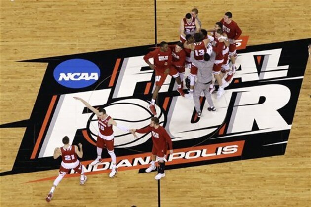 Wisconsin players celebrate after an NCAA Final Four tournament college basketball semifinal game against Kentucky Saturday, April 4, 2015, in Indianapolis. Wisconsin won 71-64. (AP Photo/David J. Phillip)