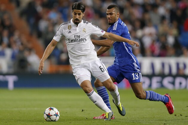 Real Madrid's Sami Khedira, left, and Schalke's Eric Maxim Choupo-Moting, right, vie for the ball during a Champions League soccer match round of 16 second leg, between Real Madrid and Schalke 04 at Santiago Bernabeu stadium, in Madrid, Spain, Tuesday, March 10, 2015. (AP Photo/Daniel Ochoa de Olza)