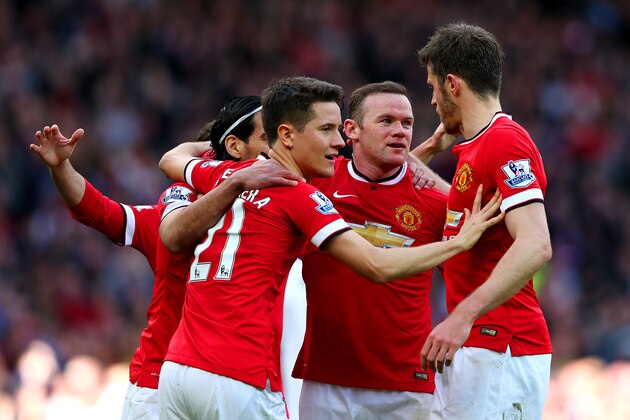MANCHESTER, ENGLAND - APRIL 04:  Wayne Rooney of Manchester United celebrates with team-mates after scoring his team's second goal during the Barclays Premier League match between Manchester United and Aston Villa at Old Trafford on April 4, 2015 in Manchester, England.  (Photo by Alex Livesey/Getty Images)