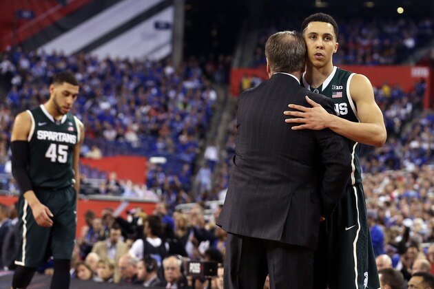 INDIANAPOLIS, IN - APRIL 04: Head coach Tom Izzo of the Michigan State Spartans hugs Travis Trice #20 after being defeated by the Duke Blue Devils during the NCAA Men's Final Four Semifinal at Lucas Oil Stadium on April 4, 2015 in Indianapolis, Indiana. Duke defeated Michigan State 81-61. (Photo by Streeter Lecka/Getty Images)