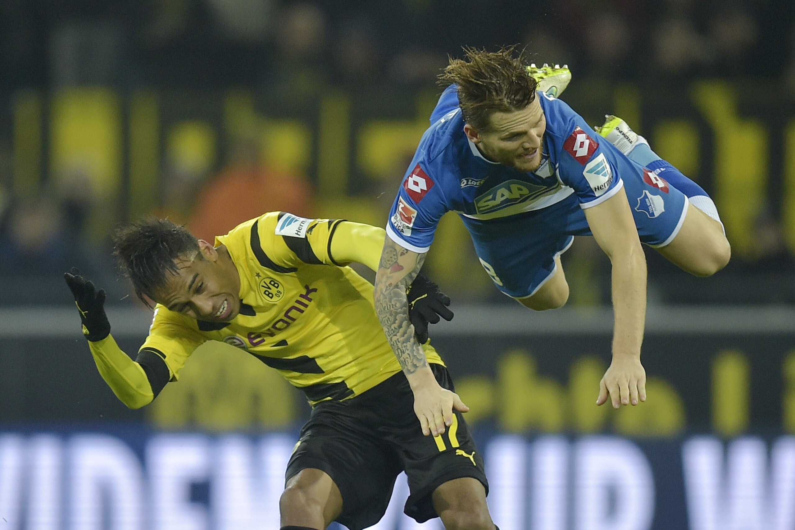 Hoffenheim's Eugen Polanski from Poland, right, and Dortmund's Pierre-Emerick Aubameyang from Gabun challenge for the ball during the German Bundesliga soccer match between Borussia Dortmund and TSG Hoffenheim in Dortmund,  Germany, Friday, Dec. 5, 2014. Dortmund won the match with 1-0. (AP Photo/Martin Meissner)
