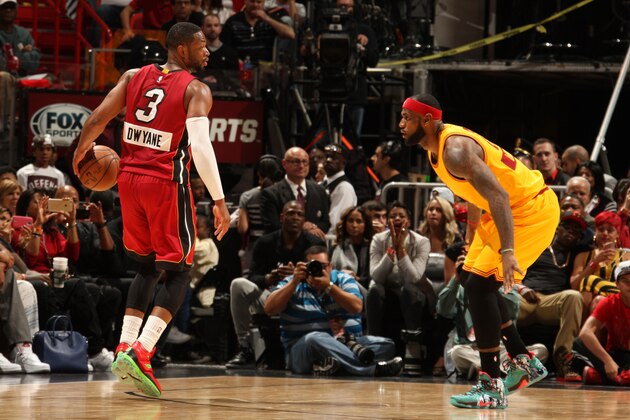 MIAMI, FL - DECEMBER 25: Dwyane Wade #3 of the Miami Heat handles the basketball while being guarded by LeBron James #23 of the Cleveland Cavaliers at the American Airlines Arena on December 25, 2014 in Miami, Florida. NOTE TO USER: User expressly acknowledges and agrees that, by downloading and/or using this Photograph, user is consenting to the terms and conditions of the Getty Images License Agreement. Mandatory Copyright Notice: Copyright 2014 NBAE (Photo by Issac Baldizon/NBAE via Getty Images)