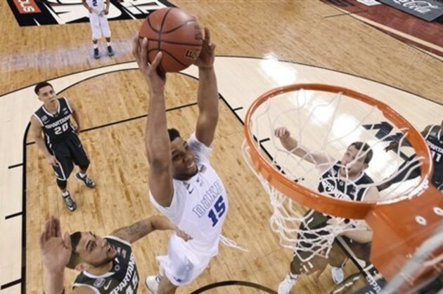 Duke's Jahlil Okafor (15) dunks the ball in front of Michigan State's Denzel Valentine (45) during the first half of the NCAA Final Four tournament college basketball semifinal game Saturday, April 4, 2015, in Indianapolis. (AP Photo/Chris Steppig, Pool)