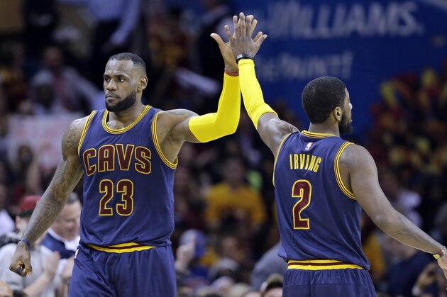 Cleveland Cavaliers' LeBron James (23) and Kyrie Irving (2) celebrate during an NBA basketball game against the Miami Heat Thursday, April 2, 2015, in Cleveland. (AP Photo/Tony Dejak)