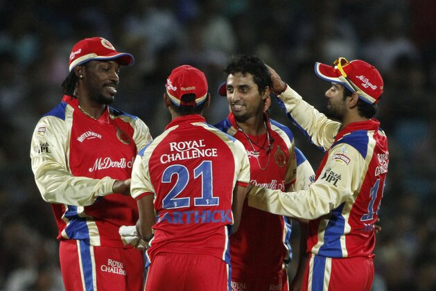 Royal Challengers Bangalore's bowler Sreenath Aravind, second right, celebrates after claiming the wicket of Johan Botha as Virat Kohli, right, and Chris Gayle, left, look on during an Indian Premier League (IPL) cricket match between Rajasthan Royals and Royal Challengers Bangalore in Jaipur, India, Wednesday, May 11, 2011. (AP Photo/Gurinder Osan)