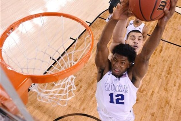 Duke's Justise Winslow (12) is fouled by Michigan State's Gavin Schilling, rear, during the second half of the NCAA Final Four tournament college basketball semifinal game Saturday, April 4, 2015, in Indianapolis. (AP Photo/Chris Steppig, Pool)