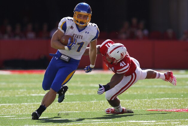 Sep 21, 2013; Lincoln, NE, USA; South Dakota State Jackrabbits running back Zach Zenner (31) runs away from Nebraska Cornhuskers defender David Santos (41) in the first quarter at Memorial Stadium. Mandatory Credit: Bruce Thorson-USA TODAY Sports
