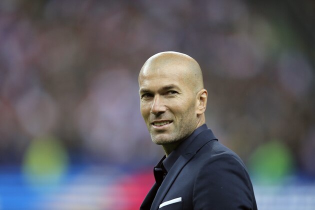 Former France's soccer player Zinedine Zidane smiles to spectators prior to the international friendly soccer match between France and Brazil at the Stade de France, north of Paris, France, Thursday, March 26, 2015. (AP Photo/Francois Mori)