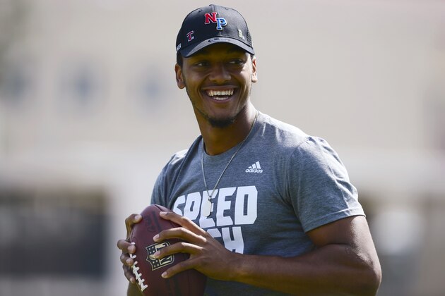 Quarterback Brett Hundley smiles while he warms up during UCLA's pro day, where players worked out for NFL football scouts at Spaulding Field in Los Angeles on Tuesday, March 10, 2015. (AP Photo/Kelvin Kuo)