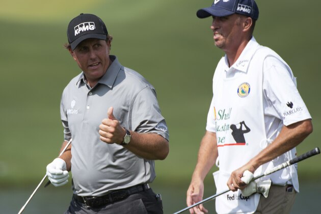 Phil Mickelson gives a thumbs-up to his caddie, Jim