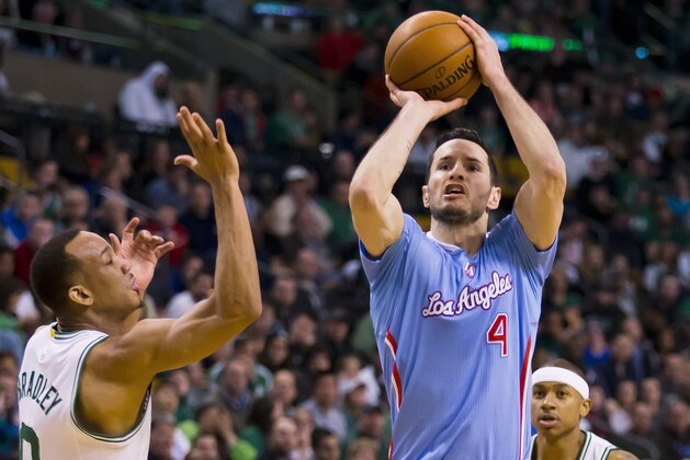 Los Angeles Clippers' J.J. Redick goes for a shot past Boston Celtics' Avery Bradley during the second half of the Clippers' 119-106 win in an NBA basketball game in Boston on Sunday, March 29, 2015. (AP Photo/Winslow Townson)