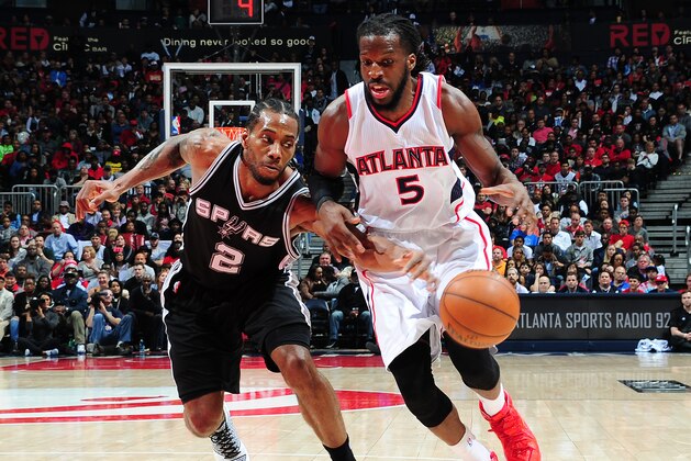 ATLANTA, GA - MARCH 22: Kawhi Leonard #2 of the San Antonio Spurs attempts to steal the ball from DeMarre Carroll #5 of the Atlanta Hawks on March 22, 2015 at Philips Arena in Atlanta, Georgia.  NOTE TO USER: User expressly acknowledges and agrees that, by downloading and/or using this Photograph, user is consenting to the terms and conditions of the Getty Images License Agreement. Mandatory Copyright Notice: Copyright 2015 NBAE (Photo by Scott Cunningham/NBAE via Getty Images)