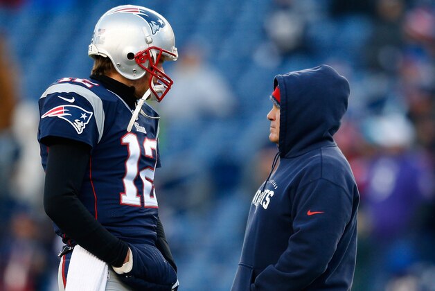 FOXBORO, MA - JANUARY 10:  Tom Brady #12 and head coach Bill Belichick of the New England Patriots talk before the 2014 AFC Divisional Playoffs game against the Baltimore Ravens at Gillette Stadium on January 10, 2015 in Foxboro, Massachusetts.  (Photo by Jim Rogash/Getty Images)