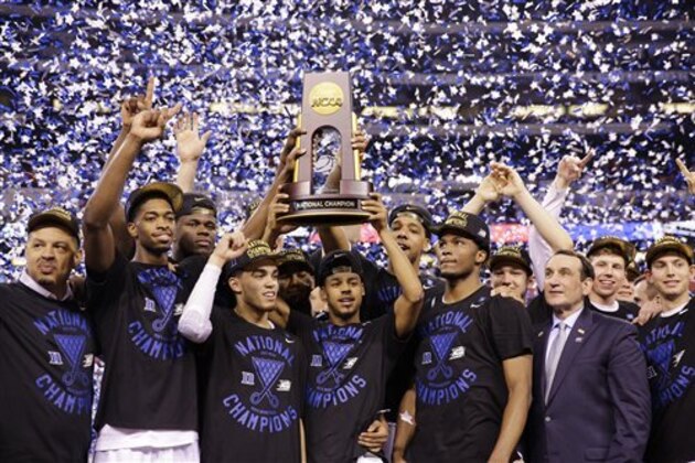 Duke players celebrate with the trophy after their 68-63 victory over Wisconsin in the NCAA Final Four college basketball tournament championship game Monday, April 6, 2015, in Indianapolis. (AP Photo/David J. Phillip)