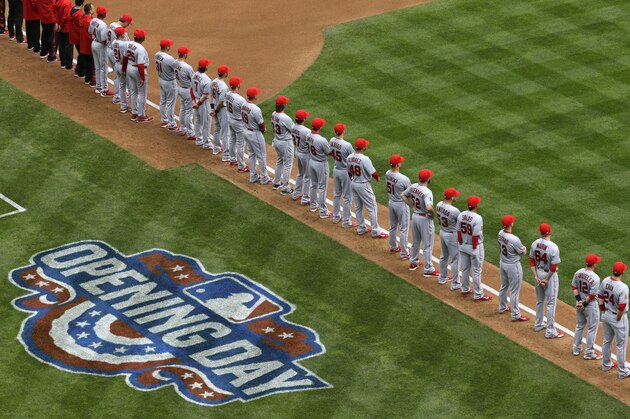 Los Angeles Angels players stand on the baseline during player introductions before an opening day baseball game against the Seattle Mariners, Monday, April 6, 2015, in Seattle. (AP Photo/Ted S. Warren)