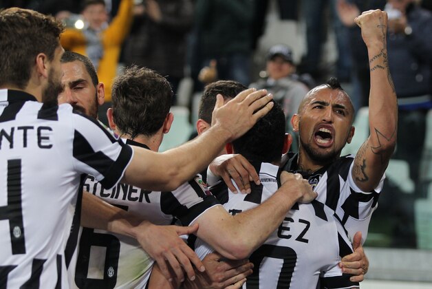 Juventus' players celebrates after Carlos Tevez scored during a Serie A soccer match between Juventus and Empoli at the Juventus stadium, in Turin, Italy, Saturday, April 4, 2015. (AP Photo/ Massimo Pinca)