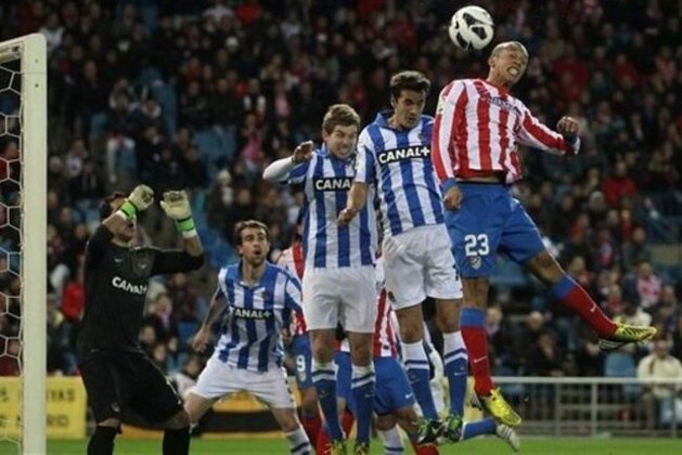 Atletico Madrid's Joao Miranda from Brazil, right, in action with Real Sociedad players during a Spanish La Liga soccer match at the Vicente Calderon stadium in Madrid, Spain, Sunday, March 10, 2013. (AP Photo/Andres Kudacki)