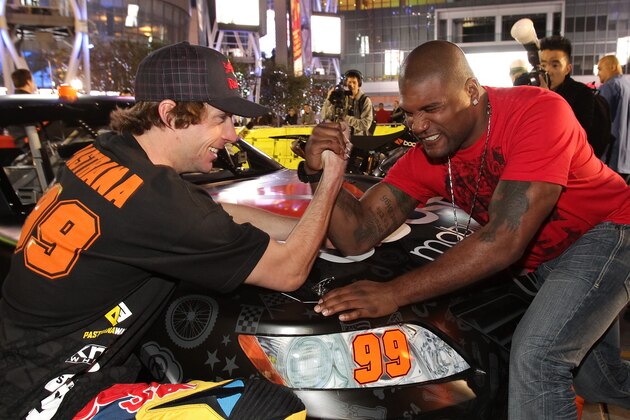 LOS ANGELES, CA - JANUARY 21:  Travis Pastrana (L) and Quinton 'Rampage' Jackson arm wrestle at the Pastrana-Waltrip Racing announcement of the 2011 NASCAR Nationwide partnership on January 21, 2011 in Los Angeles, California.  (Photo by Noel Vasquez/Getty Images for Waltrip Racing)