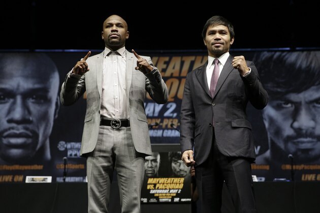Floyd Mayweather Jr., left, and Manny Pacquiao, of the Philippines, pose for photos after a news conference, Wednesday, March 11, 2015, in Los Angeles. The two are scheduled to fight in Las Vegas on May 2. (AP Photo/Jae C. Hong)