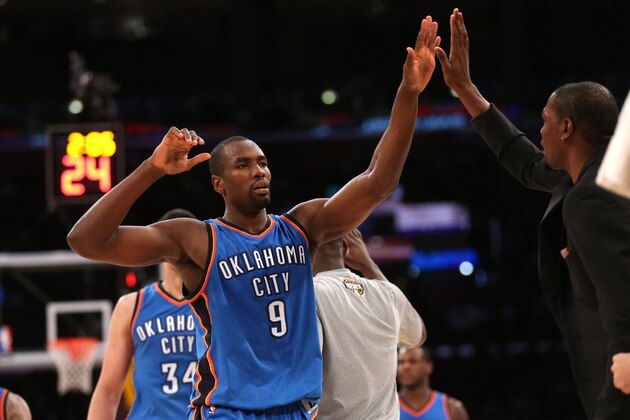 LOS ANGELES, CA - MARCH 01: Serge Ibaka#9 of the Oklahoma City Thunder is greeted by injured teammate Kevin Durant as he comes off the floor during a timeout in the fourth quarter against the Los Angeles Lakers at Staples Center on March 1, 2015 in Los Angeles, California.  The Thunder won 108-101.   NOTE TO USER: User expressly acknowledges and agrees that, by downloading and or using this photograph, User is consenting to the terms and conditions of the Getty Images License Agreement.  (Photo by Stephen Dunn/Getty Images)