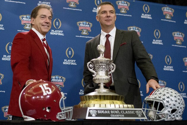 Alabama coach Nick Saban, left, and Ohio State coach Urban Meyer pose with the Sugar Bowl Classic trophy during a press conference at the Marriott downtown convention center in New Orleans, Wednesday, Dec. 31, 2014. Alabama is slated to square off against Ohio State in the Sugar Bowl NCAA college football playoff semifinal on New Year's Day. (AP Photo/Brynn Anderson)