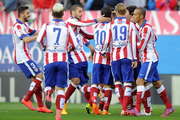 MADRID, SPAIN - APRIL 07:  Club Atletico de Madrid players celebrate after Mikel Gonzalez (unseen) of Real Sociedad scored an own goal during the La Liga match between Club Atletico de Madrid and Real Sociedad at Vicente Calderon Stadium on April 7, 2015 in Madrid, Spain.  (Photo by Denis Doyle/Getty Images)
