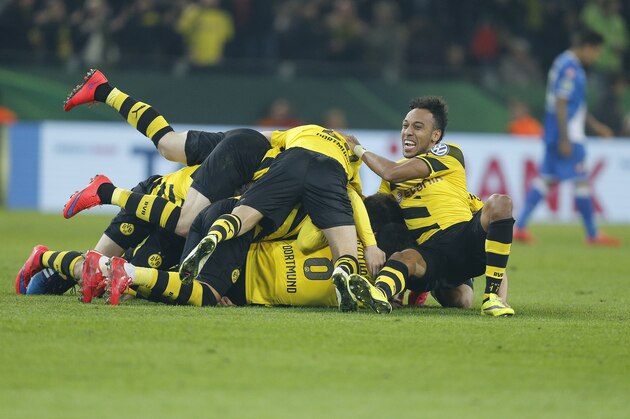 Dortmund players celebrate after scoring in extra time during the German soccer cup (DFB Pokal) quarterfinal match between BvB Borussia Dortmund and TSG 1899 Hoffenheim Tuesday, April 7, 2015 in Dortmund, Germany. (AP Photo/Frank Augstein)