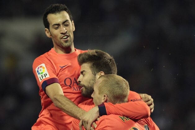 Barcelona's Jeremy Mathieu, from France, front, is congratulated by teammates Sergio Busquets, top, and Gerard Pique after scoring during a Spanish La Liga soccer match between RC Celta and Barcelona, at the Balaídos stadium in Vigo, Spain, Sunday, April 5, 2015. (AP Photo/Lalo R. Villar) Barcelona's Jeremy Mathieu, from France, front, is congratulated by teammates Sergio Busquets, top, and Gerard Pique after scoring during a Spanish La Liga soccer match between RC Celta and Barcelona, at the Balaídos stadium in Vigo, Spain, Sunday, April 5, 2015. (AP Photo/Lalo R. Villar)