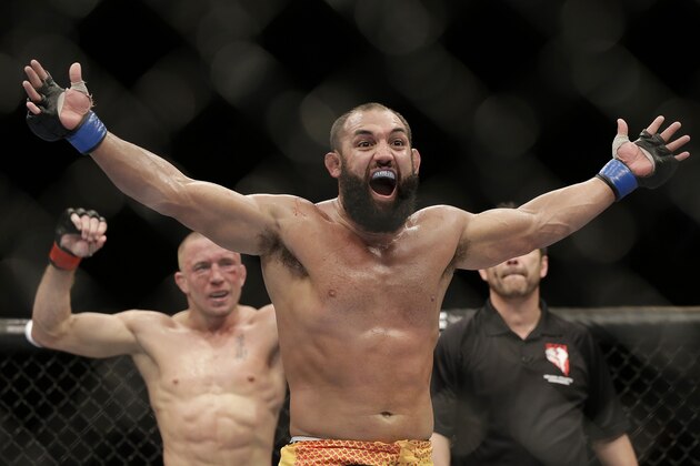 Johny Hendricks, center, reacts following a UFC 167 mixed martial arts championship welterweight bout on against Georges St. Pierre, of Canada, on Saturday, Nov. 16, 2013, in Las Vegas. St. Pierre won by split decision. (AP Photo/Isaac Brekken)