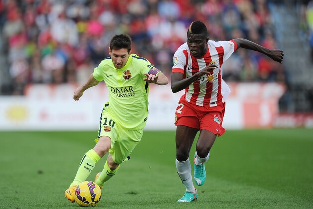 ALMERIA, SPAIN - NOVEMBER 08:  Lionel Messi of FC Barcelona is challenged by Thomas Partey of UD Almeria during the La Liga match between UD Almeria and FC Barcelona at estadio de los Juegos Mediterraneos on November 8, 2014 in Almeria, Spain.  (Photo by Denis Doyle/Getty Images)