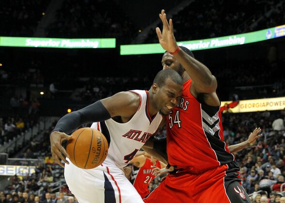 Atlanta Hawks forward Paul Millsap (4) is fouled by Toronto Raptors forward Patrick Patterson (54) in the second period in an NBA basketball game in Atlanta, Wednesday, Nov. 26, 2014. (AP Photo/Todd Kirkland)