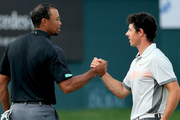 DUBAI, UNITED ARAB EMIRATES - JANUARY 31:  Rory McIlroy of Northern Ireland and Tiger Woods of the USA shake hands on the 18th greenduring the second round of the 2014 Omega Dubai Desert Classic on the Majlis Course at the Emirates Golf Club on January 31, 2014 in Dubai, United Arab Emirates. .  (Photo by Francois Nel/Getty Images)