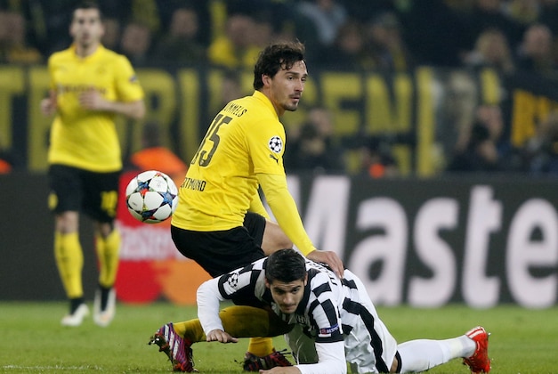 Juventus' Alvaro Morata, bottom, is challenged by Dortmund's Mats Hummels during the Champions League round of 16 second leg soccer match between Borussia Dortmund and Juventus Turin on Wednesday, March 18, 2015 in Dortmund, Germany. (AP Photo/Frank Augstein)