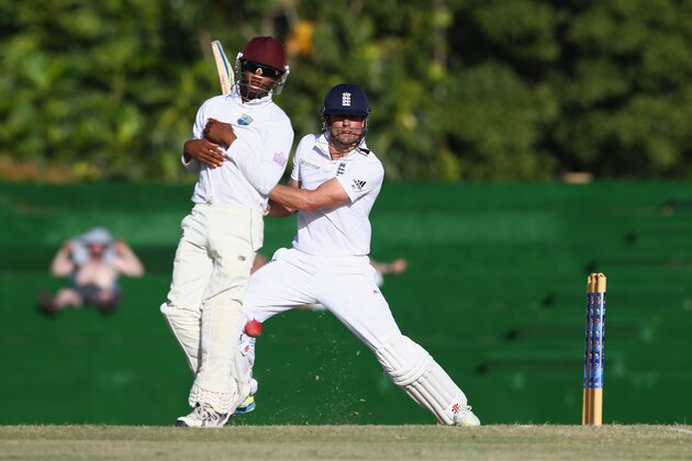BASSETERRE, ST KITTS, SAINT KITTS AND NEVIS - APRIL 06:  Alastair Cook of England hits square as Ross Powell of St Kitts takes evasive action during the St Kitts and Nevis Invitational XI versus  England tour match on April 6, 2015 in Basseterre, St Kitts, Saint Kitts and Nevis.  (Photo by Michael Steele/Getty Images)