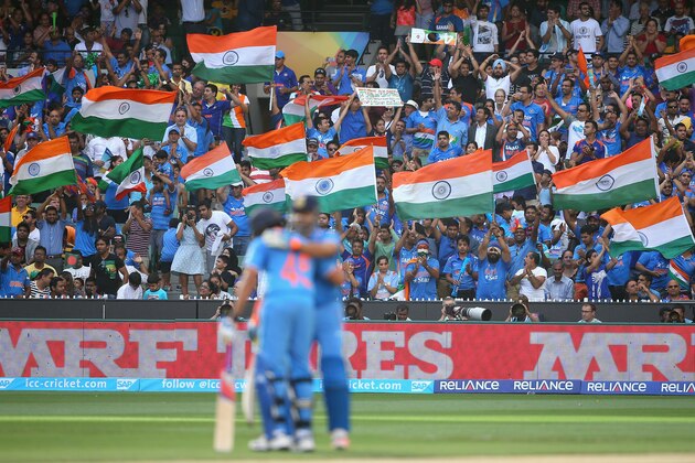 MELBOURNE, AUSTRALIA - MARCH 19:  Fans celebrate as Suresh Raina of India celebrates making 50 runs during the 2015 ICC Cricket World Cup Quater Final match between India and Bangldesh at Melbourne Cricket Ground on March 19, 2015 in Melbourne, Australia.  (Photo by Quinn Rooney/Getty Images)